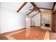 Living room with beamed ceilings, hardwood floors, and decorative fireplace, creating an inviting atmosphere at 100 Crestwood Dr, Longwood, FL 32779