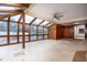 Spacious sunroom filled with natural light from the glass ceiling and wood frame, offering a pool view at 100 Crestwood Dr, Longwood, FL 32779