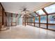 Bright sunroom enclosed by glass walls and a wood frame, providing access to a pool area at 100 Crestwood Dr, Longwood, FL 32779