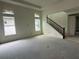 Spacious living room features ample natural light and staircase access at 10043 Dulbecco St, Orlando, FL 32827