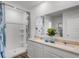 Modern bathroom with dual sinks, quartz countertops, and a walk-in shower at 1012 Bear Hammock Dr, Umatilla, FL 32784