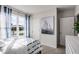 Well-lit bedroom with large window and nautical-themed artwork at 1012 Bear Hammock Dr, Umatilla, FL 32784