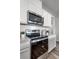 Contemporary kitchen equipped with stainless steel appliances, sleek countertops, and stylish cabinetry at 1012 Bear Hammock Dr, Umatilla, FL 32784