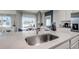 Beautiful kitchen with a large island, stainless steel sink, and modern fixtures, perfect for cooking and entertaining at 1012 Bear Hammock Dr, Umatilla, FL 32784