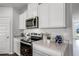 Well-equipped kitchen with stainless steel appliances, sleek countertops, and plenty of cabinet space at 1012 Bear Hammock Dr, Umatilla, FL 32784