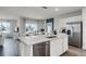 Modern kitchen with a large island, stainless steel appliances, open layout, and abundant natural light at 1012 Bear Hammock Dr, Umatilla, FL 32784