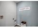 Bright laundry room with gray walls and essential washer hookups at 1012 Bear Hammock Dr, Umatilla, FL 32784
