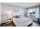 Serene main bedroom with decorative wallpaper, large window, and stylish decor at 1012 Bear Hammock Dr, Umatilla, FL 32784