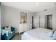 Bright main bedroom features a cozy blue chair, dresser with mirror, and luxury vinyl flooring at 1012 Bear Hammock Dr, Umatilla, FL 32784