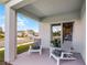 Relaxing outdoor patio with comfortable seating, offering a serene view of the neighborhood at 1012 Bear Hammock Dr, Umatilla, FL 32784