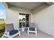 Cozy covered patio featuring modern chairs and a sliding glass door for seamless indoor-outdoor living at 1012 Bear Hammock Dr, Umatilla, FL 32784