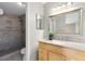 Bright bathroom featuring granite counters, vanity with storage, and a tile shower at 1103 Saddleback Ridge Rd, Apopka, FL 32703