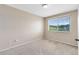 Bedroom with neutral walls, carpet, and a large window with a view at 1103 Saddleback Ridge Rd, Apopka, FL 32703
