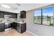 Cozy kitchen features stainless steel appliances and a large window overlooking a beautiful lake at 1103 Saddleback Ridge Rd, Apopka, FL 32703