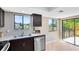 Bright kitchen with stainless steel dishwasher, double sink, and sliding glass door to patio at 1103 Saddleback Ridge Rd, Apopka, FL 32703
