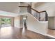 Inviting living room features wood floors, a staircase, and scenic lake views at 1103 Saddleback Ridge Rd, Apopka, FL 32703