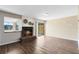 Bright living room featuring wood floors, a brick fireplace, and an open layout at 1103 Saddleback Ridge Rd, Apopka, FL 32703