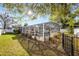 Fenced backyard with a screened pool enclosure and manicured landscaping at 1231 Glastonberry Rd, Maitland, FL 32751