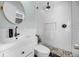 Modern bathroom with white subway tile, matte black fixtures, patterned floor, and glass-enclosed shower at 1231 Glastonberry Rd, Maitland, FL 32751