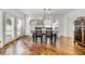 Bright dining room with shuttered windows, hardwood floors, and modern chandelier, adjacent to French doors at 1231 Glastonberry Rd, Maitland, FL 32751