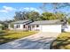 Charming one-story home with a manicured front lawn and a two-car garage, offering classic curb appeal at 1231 Glastonberry Rd, Maitland, FL 32751