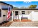 Inviting front porch with brick flooring, a bench, and the American flag displayed, enhancing the home's patriotic charm at 1231 Glastonberry Rd, Maitland, FL 32751