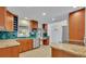 Well-lit kitchen featuring tile backsplash, granite countertops, and stainless steel appliances at 1231 Glastonberry Rd, Maitland, FL 32751