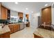 Well-lit kitchen featuring granite countertops, stainless steel appliances, and custom cabinets for ample storage at 1231 Glastonberry Rd, Maitland, FL 32751