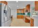 Spacious kitchen with stainless steel refrigerator, tile backsplash, and granite countertops at 1231 Glastonberry Rd, Maitland, FL 32751