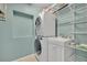 Well organized laundry room with stacked washer and dryer, sink, and shelving at 1231 Glastonberry Rd, Maitland, FL 32751