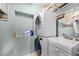 Laundry room with stacked washer and dryer, utility sink, and shelving at 1231 Glastonberry Rd, Maitland, FL 32751