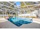Enclosed swimming pool with blue tile, surrounded by a screened enclosure at 1231 Glastonberry Rd, Maitland, FL 32751