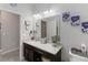 Bathroom with a granite vanity countertop and a framed mirror on the wall at 12335 Sumter Dr, Orlando, FL 32824
