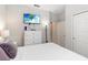 Bedroom with neutral walls, a wall mounted TV, and an adjacent doorway at 12335 Sumter Dr, Orlando, FL 32824