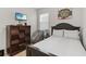Bedroom featuring neutral walls, a dark wood bed frame, and a dresser at 12335 Sumter Dr, Orlando, FL 32824