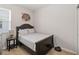 Bedroom with a dark wood frame bed, bedside table, and robot vacuum at 12335 Sumter Dr, Orlando, FL 32824