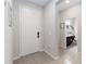 Bright foyer featuring neutral tile flooring, a white front door, and a glimpse of a half bath at 12335 Sumter Dr, Orlando, FL 32824