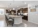 Spacious kitchen boasts dark cabinets, stainless steel appliances, and a large center island with bar seating at 12335 Sumter Dr, Orlando, FL 32824
