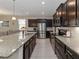 Modern kitchen equipped with stainless steel appliances, dark wood cabinets, and a sizable island at 12335 Sumter Dr, Orlando, FL 32824