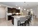 Well-appointed kitchen features a large island with seating, dark cabinetry, and modern lighting fixtures at 12335 Sumter Dr, Orlando, FL 32824