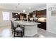 Stylish kitchen complete with a granite island, stainless appliances, dark cabinets, and pendant lighting at 12335 Sumter Dr, Orlando, FL 32824