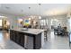 Open-concept kitchen offers bar-style seating, stainless dishwasher and sink, and access to the living and dining areas at 12335 Sumter Dr, Orlando, FL 32824