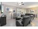 Cozy living room features tile flooring, a ceiling fan, and comfortable seating at 12335 Sumter Dr, Orlando, FL 32824