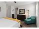 Main bedroom with wood floors, dresser, turquoise chair and a full-length mirror at 12335 Sumter Dr, Orlando, FL 32824