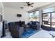 Cozy covered patio features comfortable seating, a ceiling fan, and outdoor entertainment setup at 12335 Sumter Dr, Orlando, FL 32824