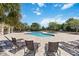 Inviting community pool area with sun loungers and lush landscaping, perfect for relaxation at 12335 Sumter Dr, Orlando, FL 32824