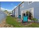 Inviting backyard with lawn, patio, and sliding glass doors for indoor-outdoor living at 135 Orchid Dr, Davenport, FL 33897