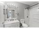 The bathroom has a shower and tub combination with a large mirror and sink at 135 Orchid Dr, Davenport, FL 33897