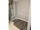 Modern bathroom features an enclosed shower, wood floors, and neutral tones at 135 Orchid Dr, Davenport, FL 33897