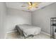 Simple bedroom design with a ceiling fan, a bed, and a metal storage shelf at 135 Orchid Dr, Davenport, FL 33897